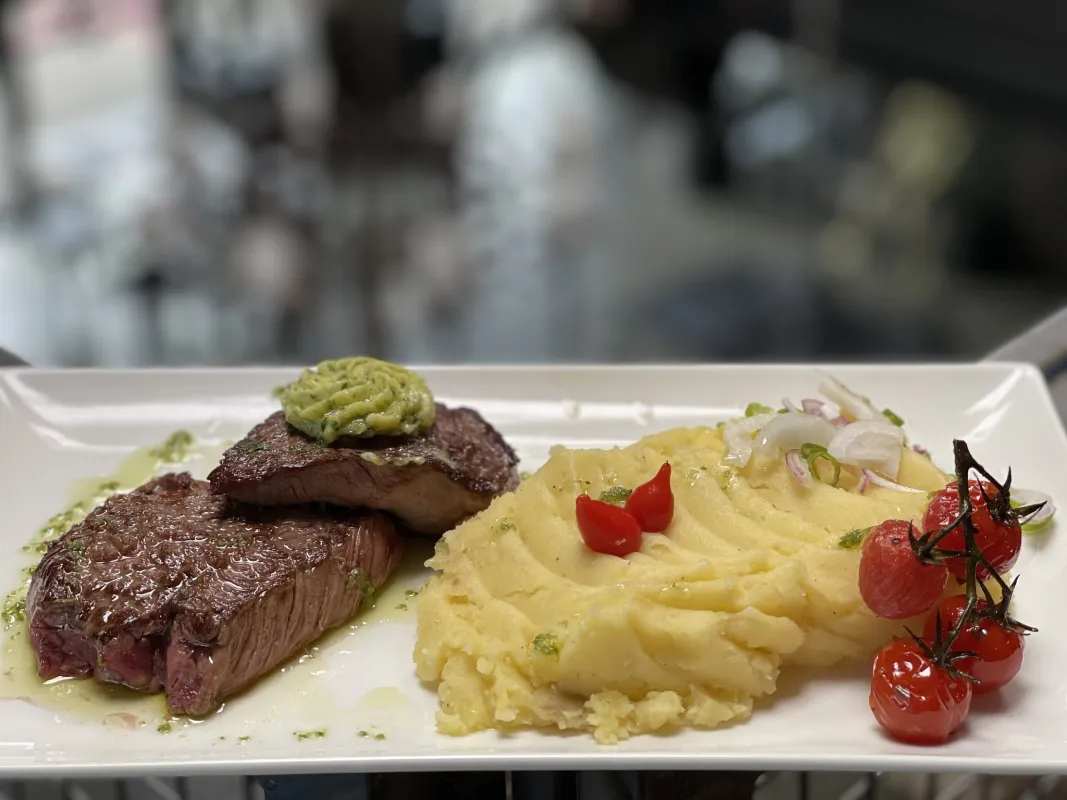 Cœur de rumsteak de bœuf, café de Paris, écrasé de pommes de terre, tomates cerises rôties, huile d'herbe